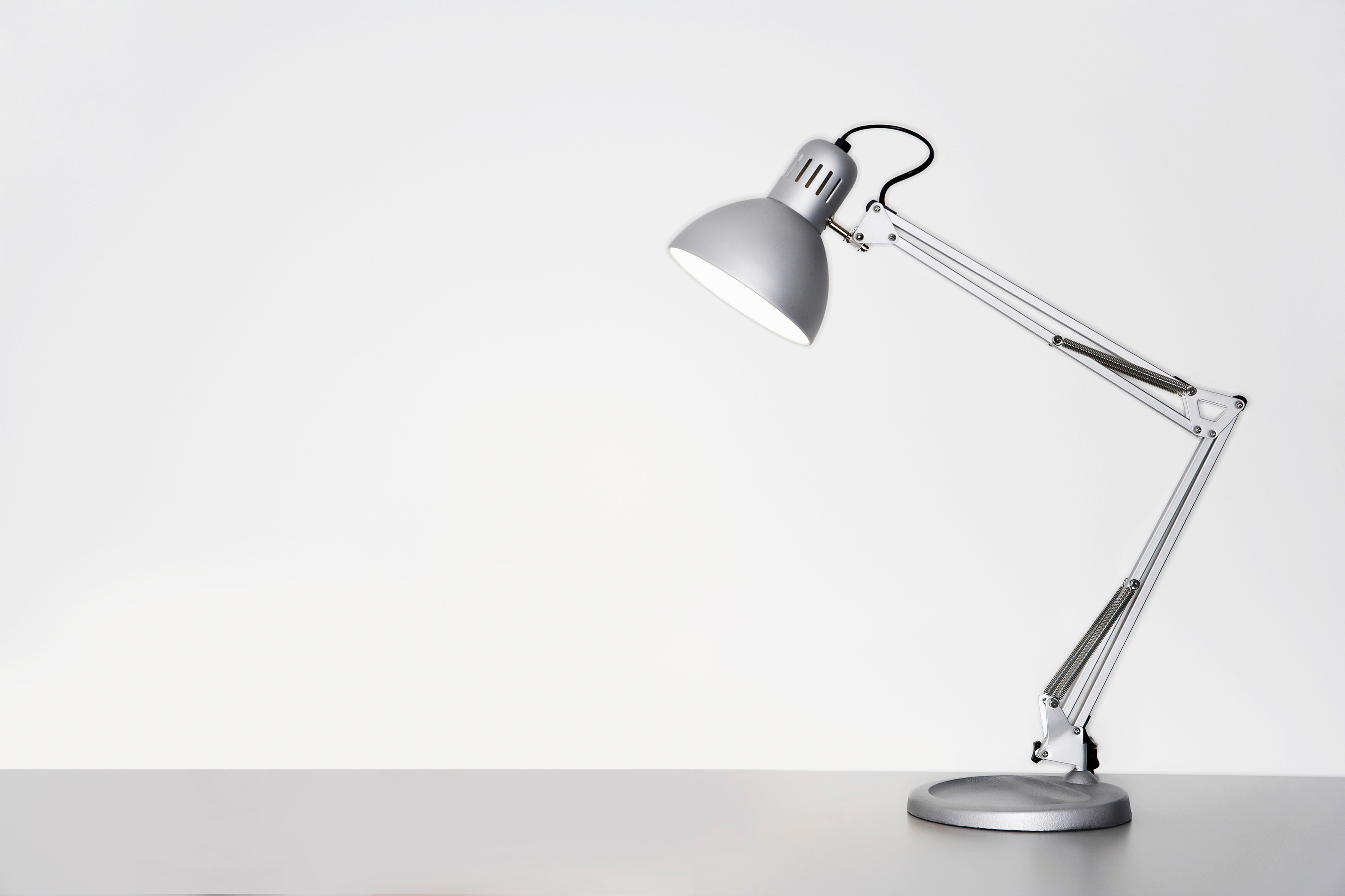 Desk lamp on table over white background